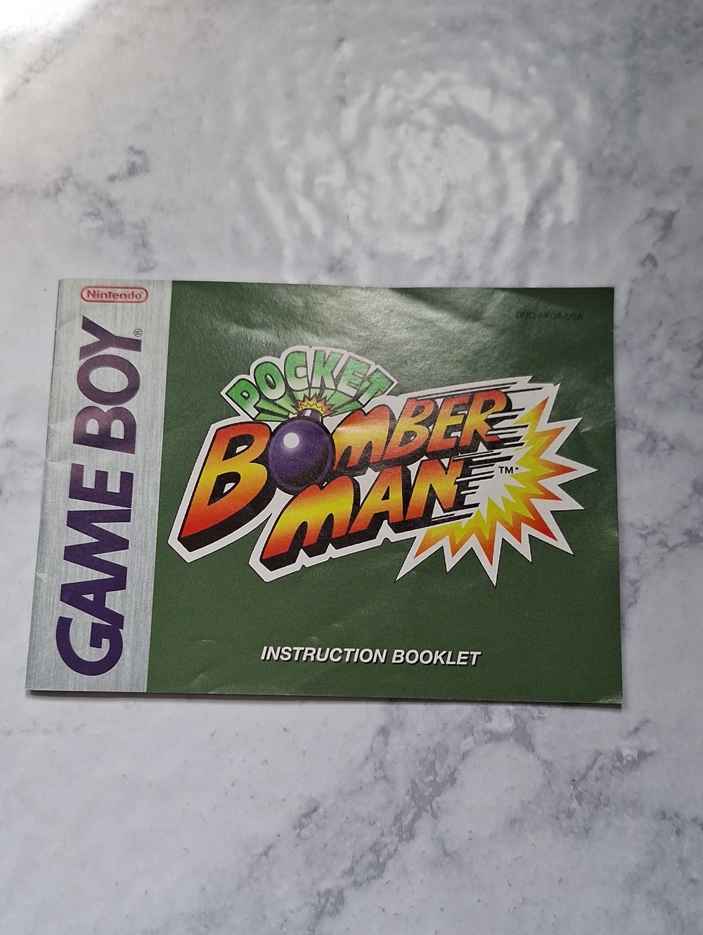 Nintendo Pocket Bomberman Instruction Booklet - Green Cover with Multicolor Logo